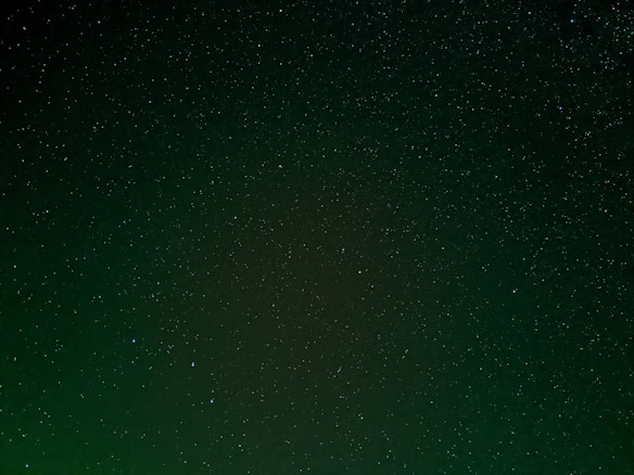 A vast expanse of a night sky filled with countless stars, scattered against a dark backdrop. The scene exudes a sense of calm and wonder, with stars varying in brightness and size across the entire image.