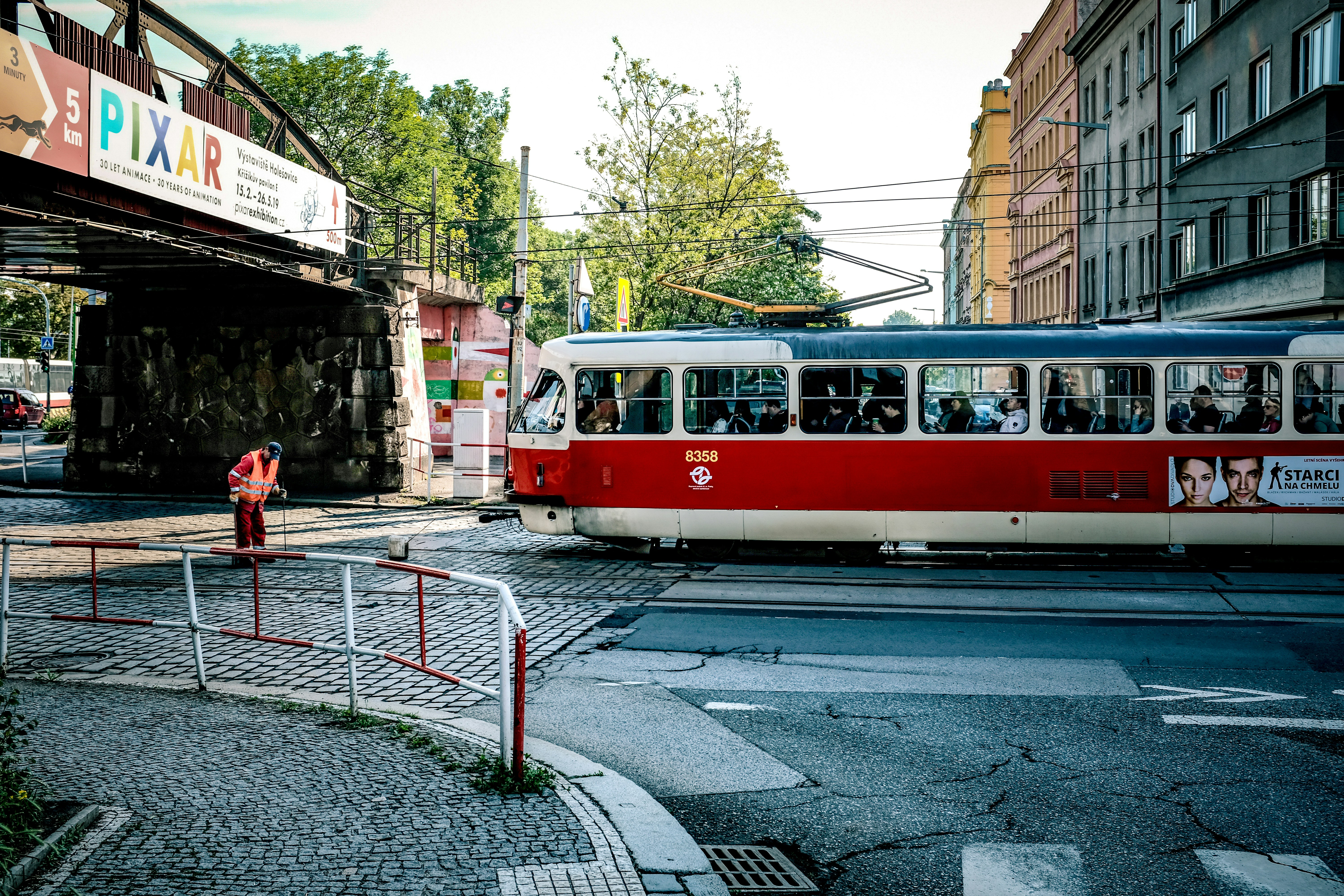 a red and white trolley on a street