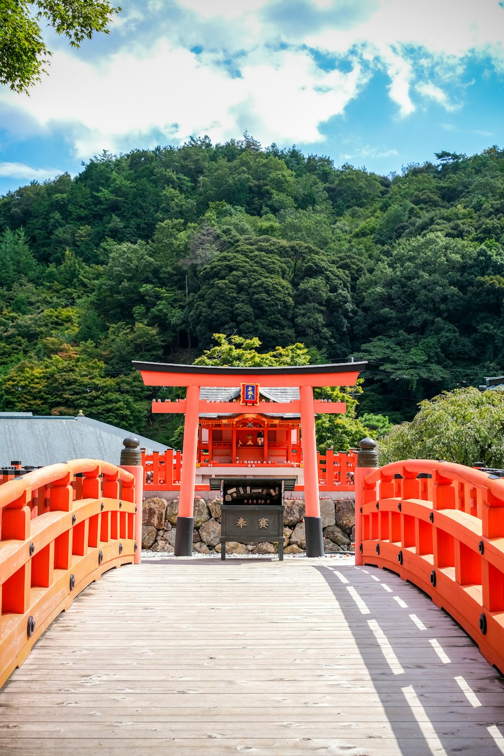 a red gateway with trees in the background