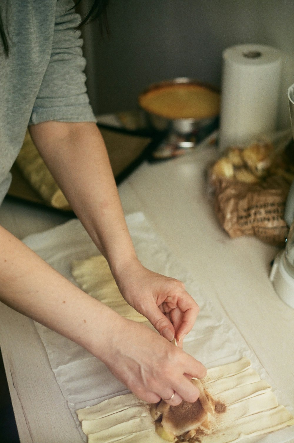 a person cutting a piece of bread