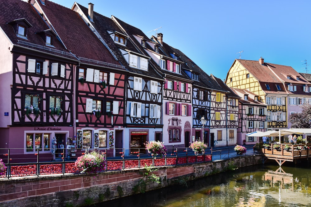 a row of buildings next to a body of water