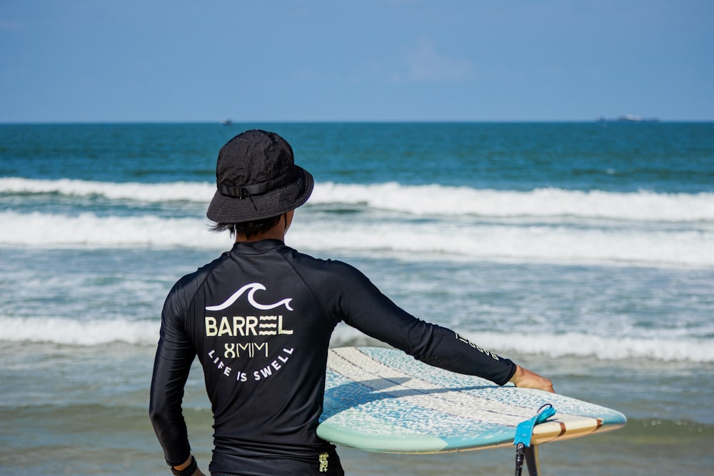 a person carrying a surfboard