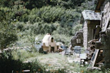 Wide shot of the eco-friendly kiln surrounded by lush Peruvian landscape.