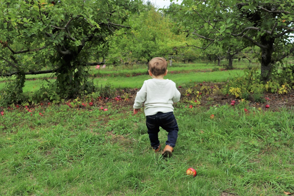 a child walking in a grassy area