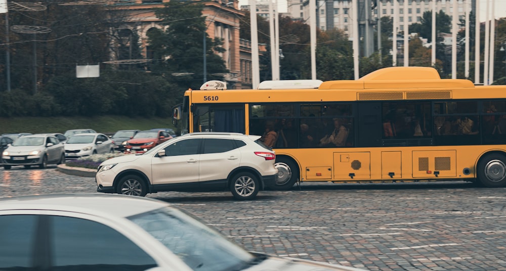 a yellow bus and cars on a street