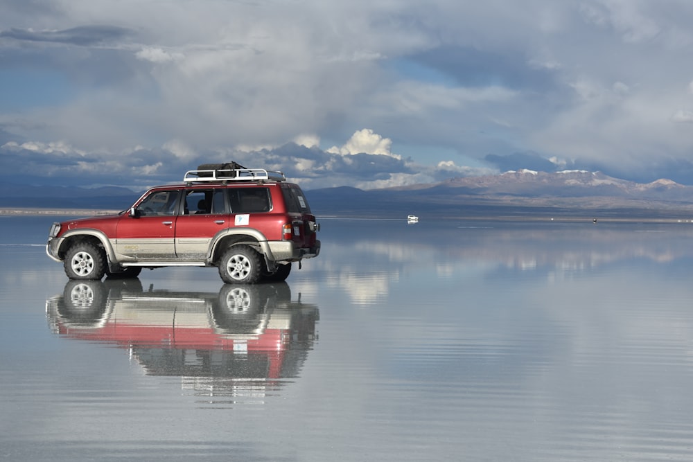 a red truck on a lake