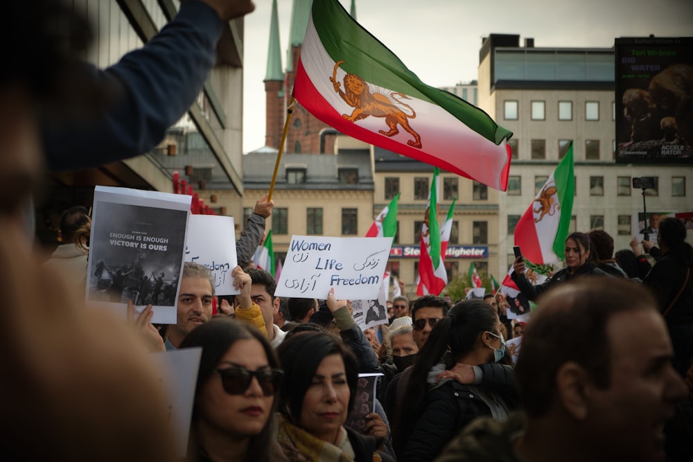 a crowd of people holding signs