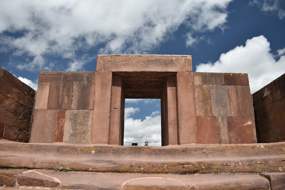 a stone structure with a door with Tiwanaku in the background