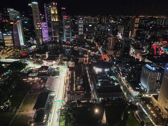 A vibrant screenshot of a futuristic racing game with neon-lit cityscapes.