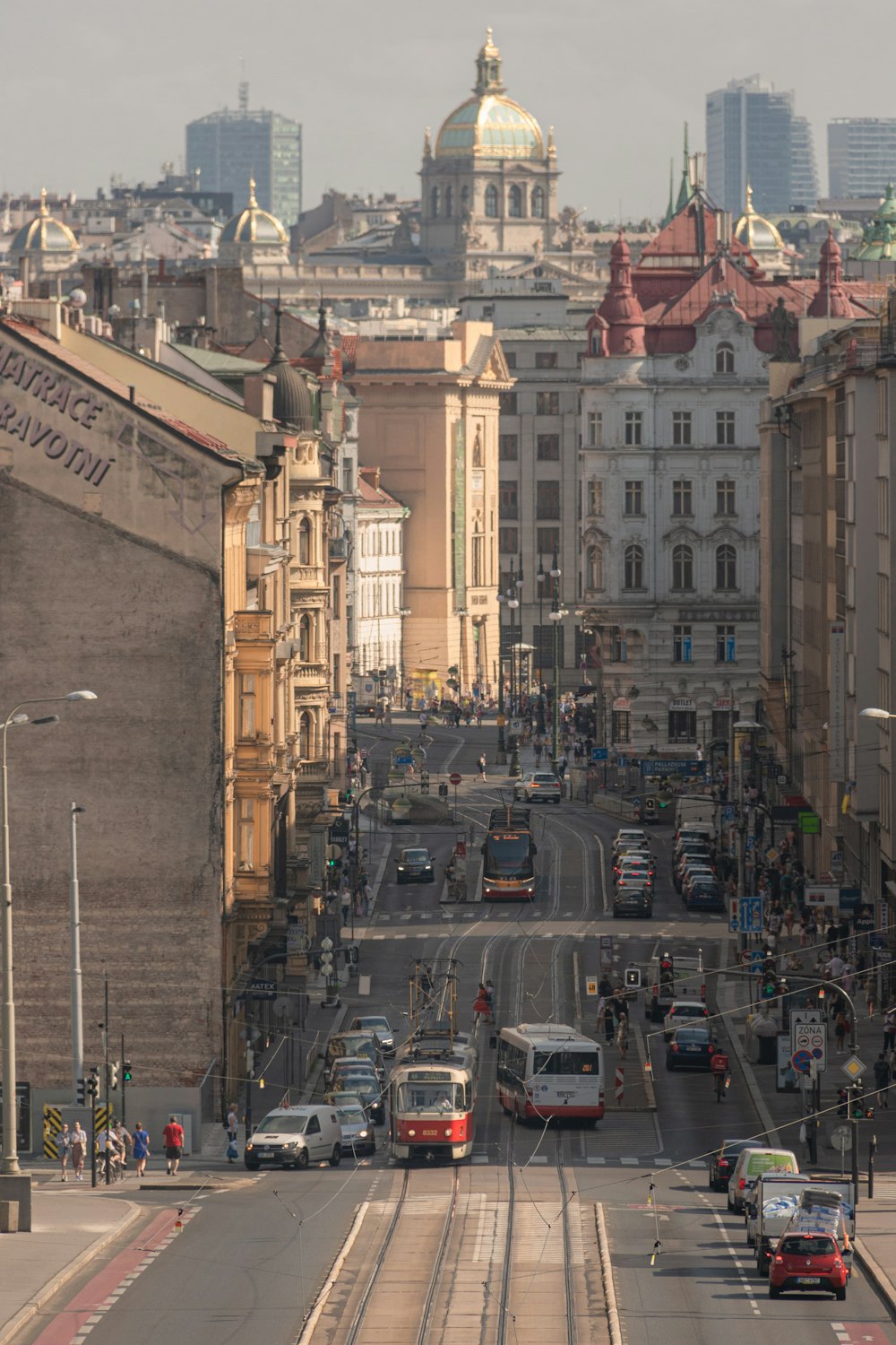 a city street with cars and buses