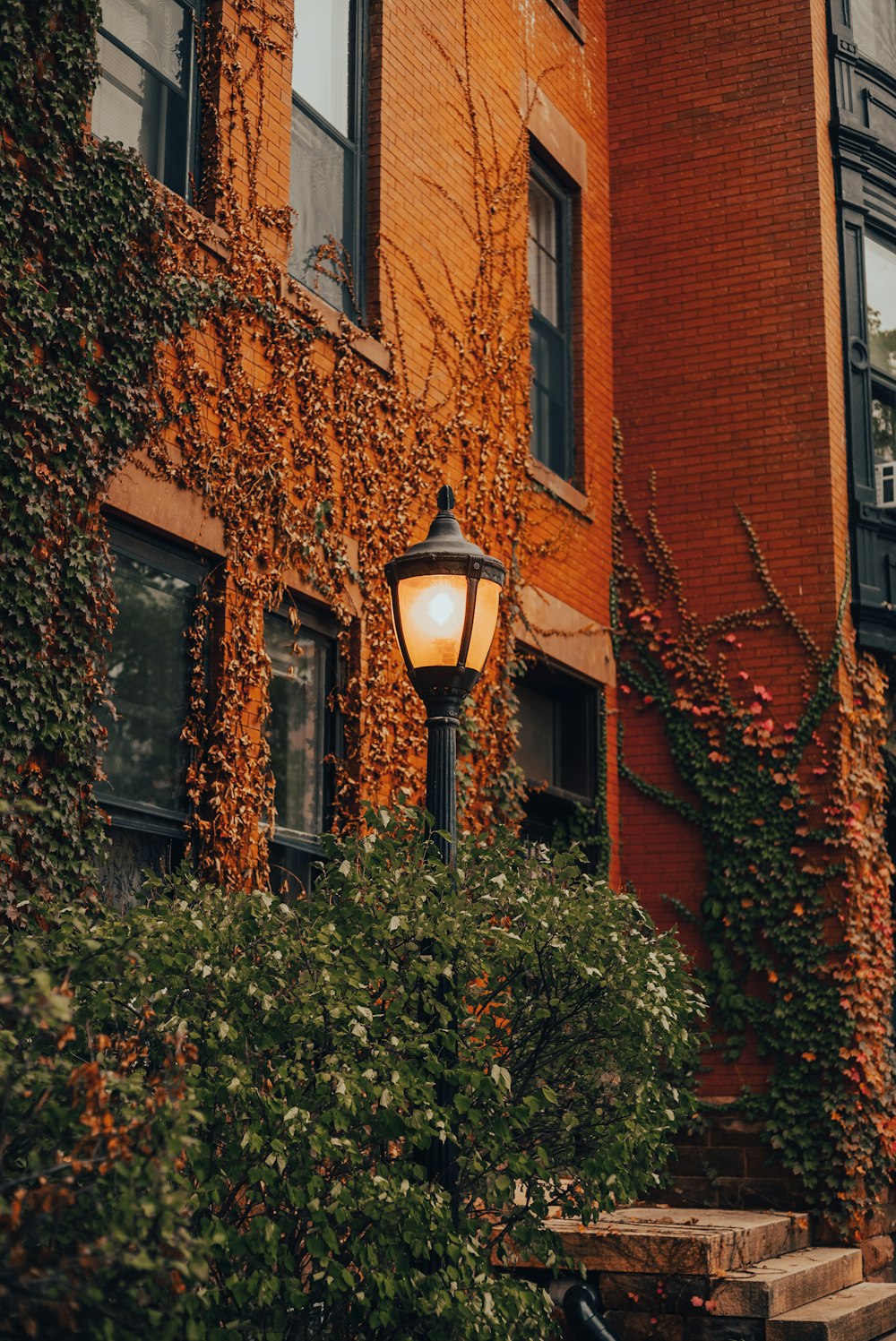 a lamp post in front of a brick building