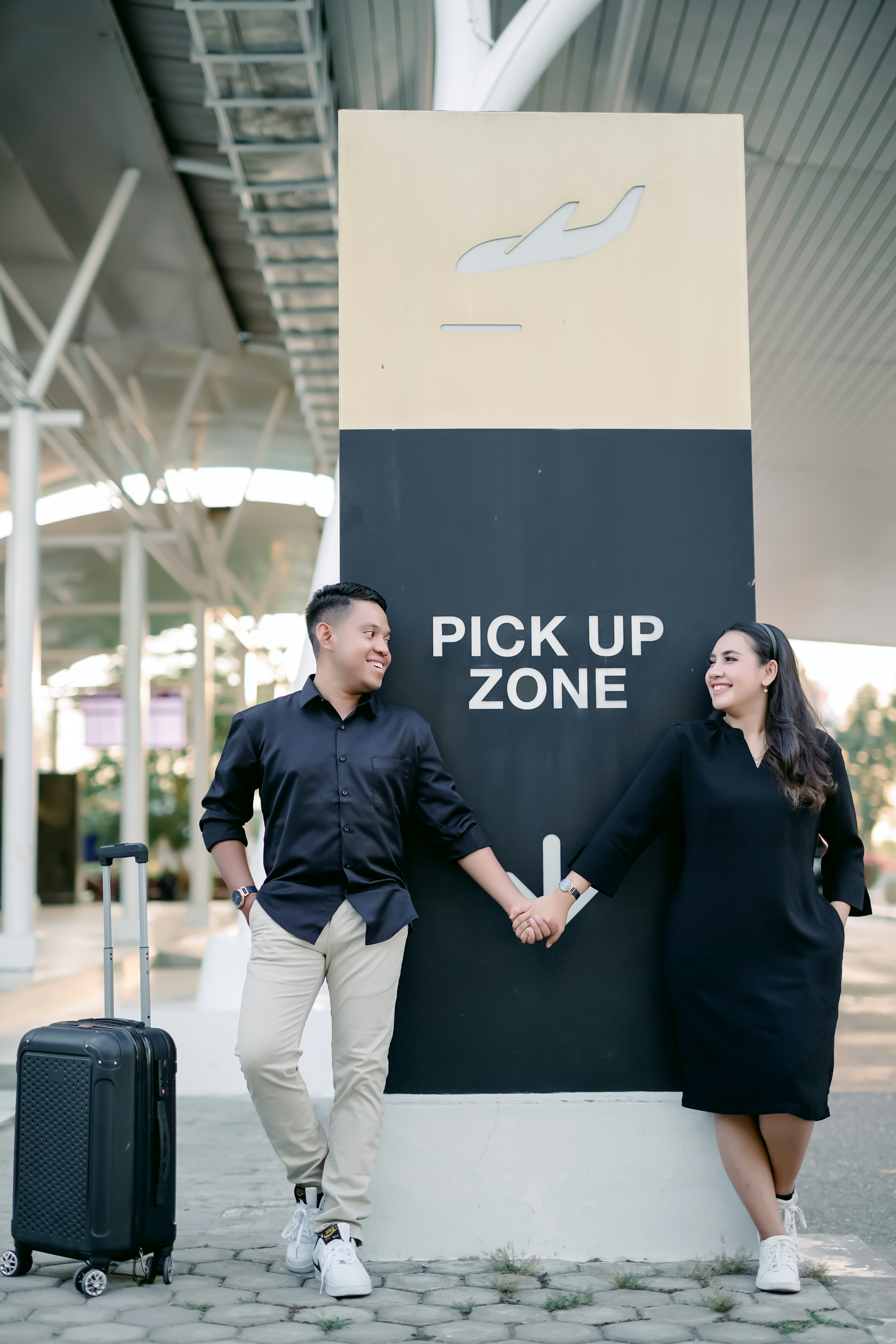 a man and woman walking by a sign