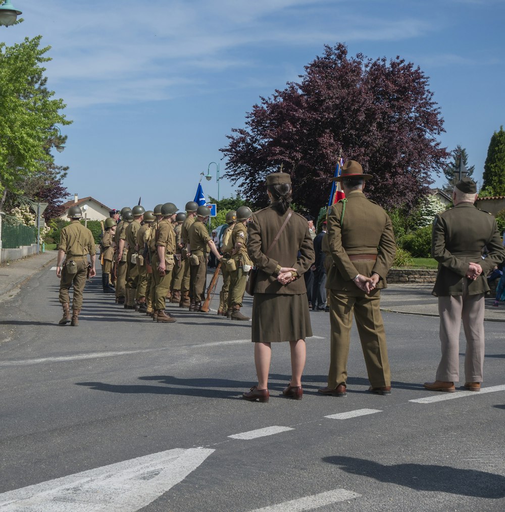 a group of people in military uniforms walking down a street