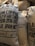 Several burlap sacks labeled as clean coffee, originating from Guatemala, are stacked together. The sacks display text including the year 2016-2017 and other product details. The texture of the sacks is coarse and natural.