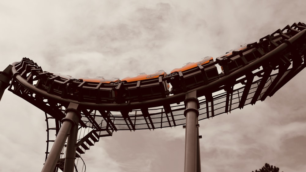 a roller coaster with a cloudy sky