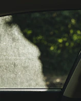 Comparison of two car windows, one with and one without solar protection film.