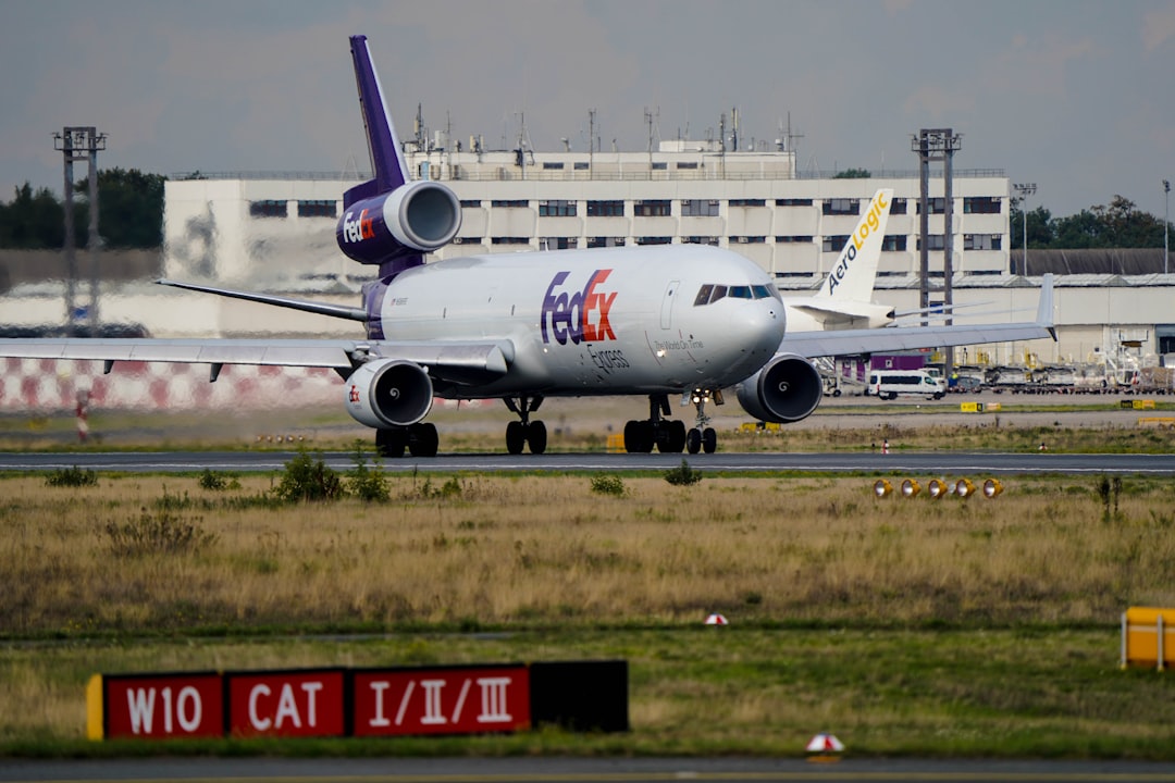 a large airplane on the runway, FedEx McDonnell Douglas MD-11F from Frankfurt to Paris during takeoff.