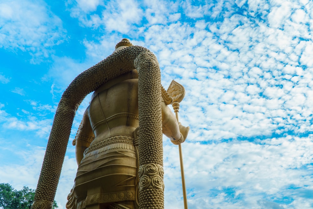 a statue of a person holding a staff