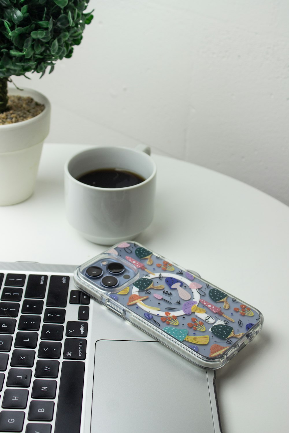 a cup of coffee and a game controller on a laptop