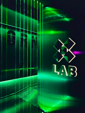 Futuristic technology lab bathed in subtle dark gradients with gold accents.