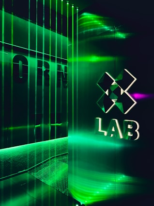 Futuristic cyberpunk style lab with glowing blue and green AI interfaces on dark background.