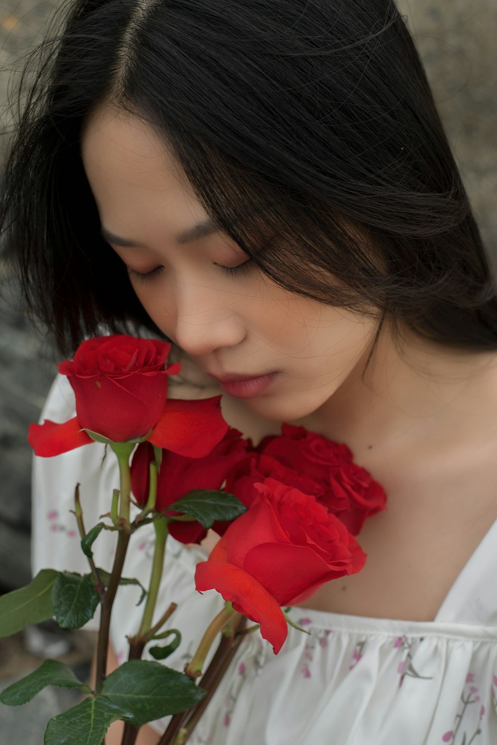 a woman smelling a rose