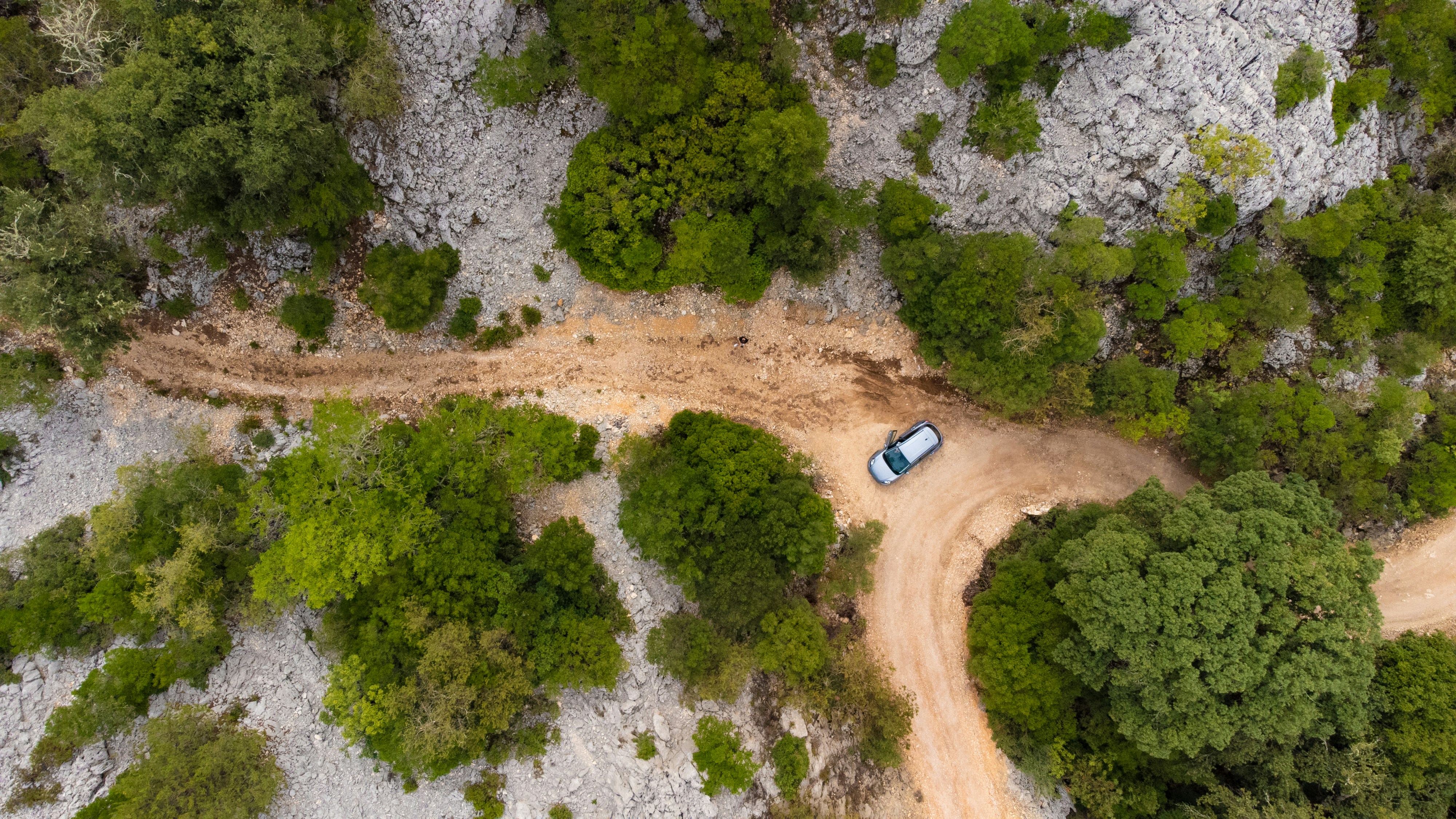 a car driving on a dirt road