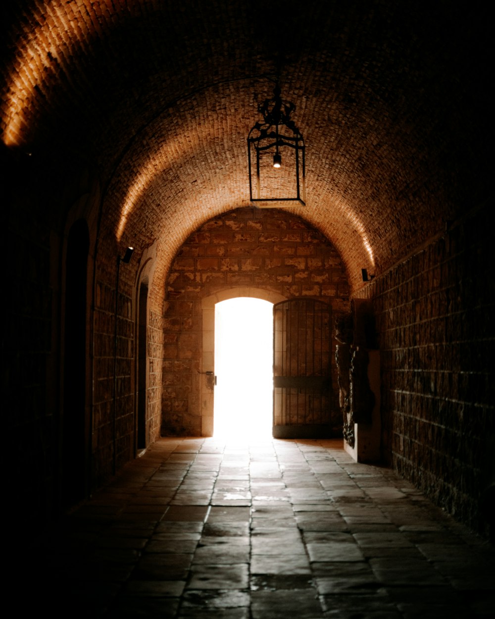 a hallway with a light on the end