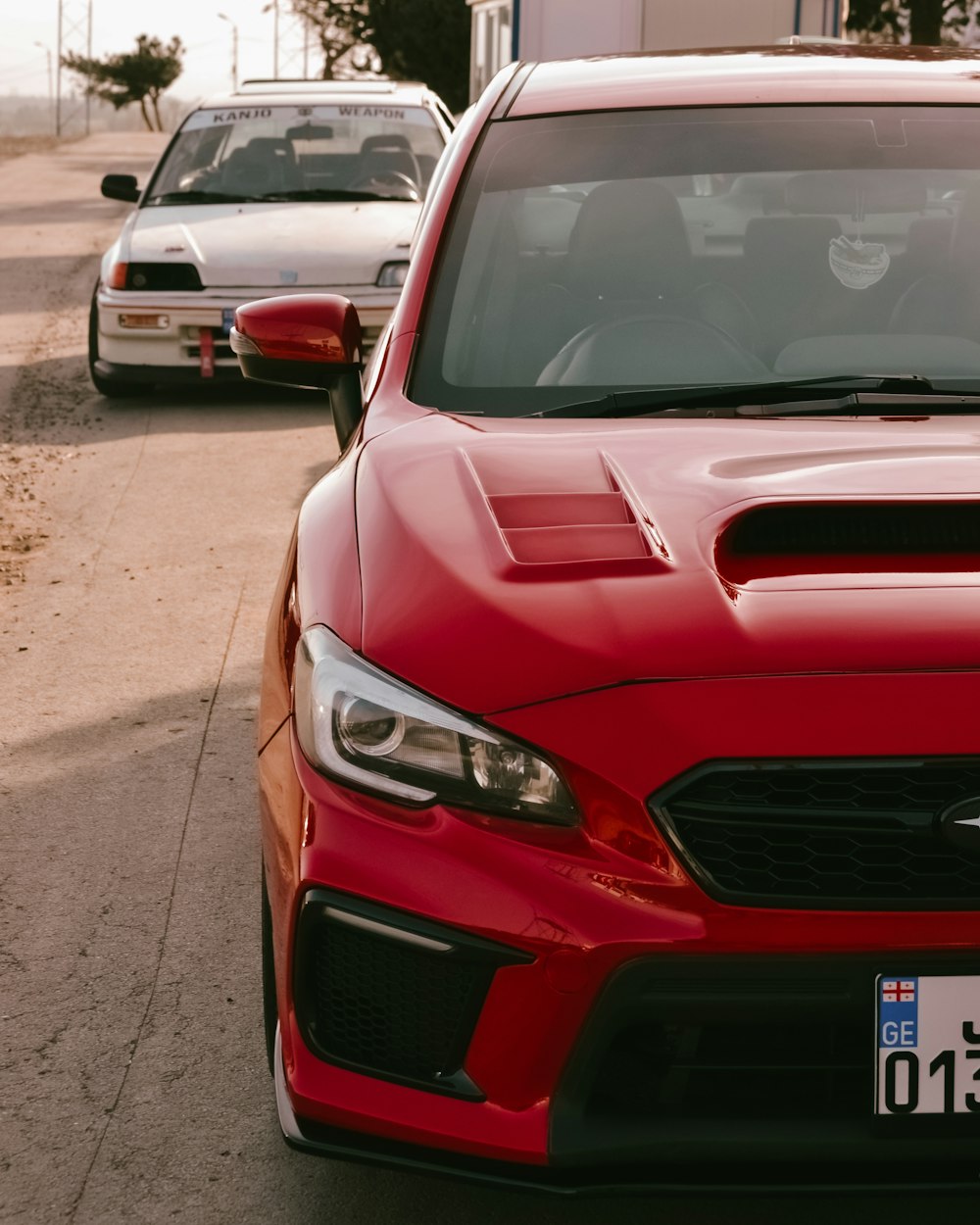 a red car parked on the side of the road