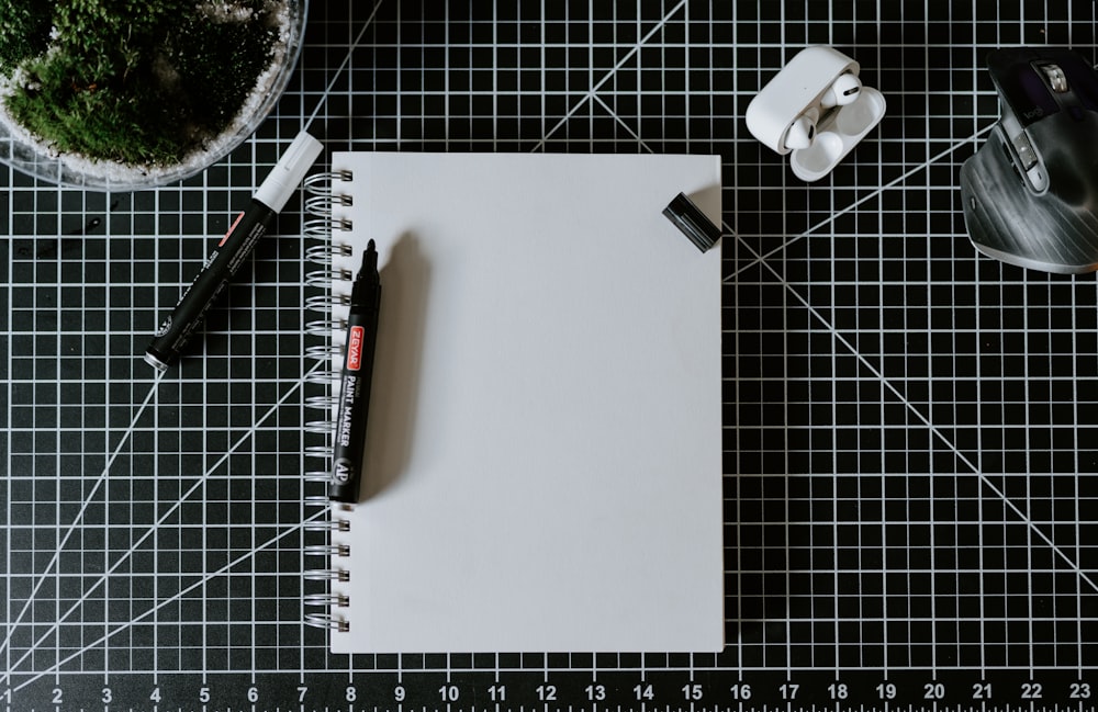 a pen and a notebook on a table