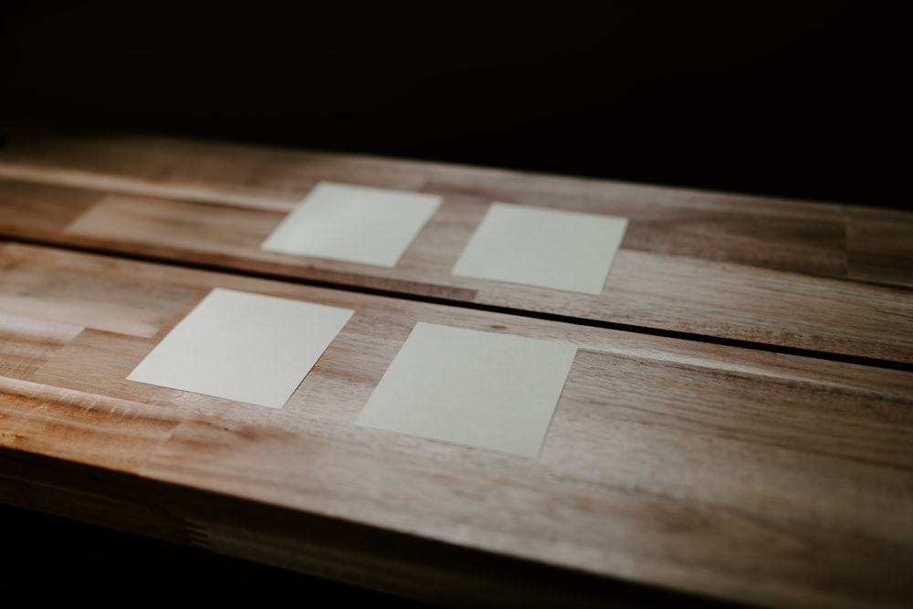 a group of white squares on a wooden surface