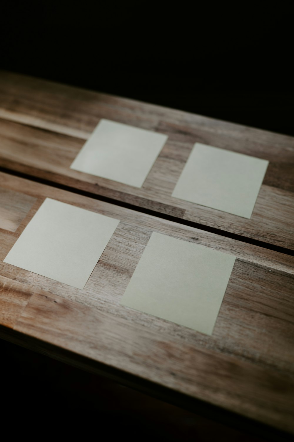 a group of square objects on a wooden surface