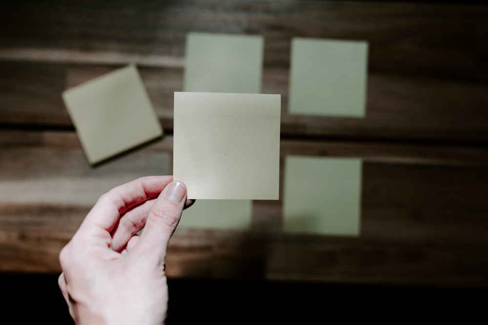 a hand holding a piece of paper