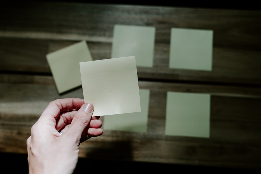 a hand holding a piece of paper