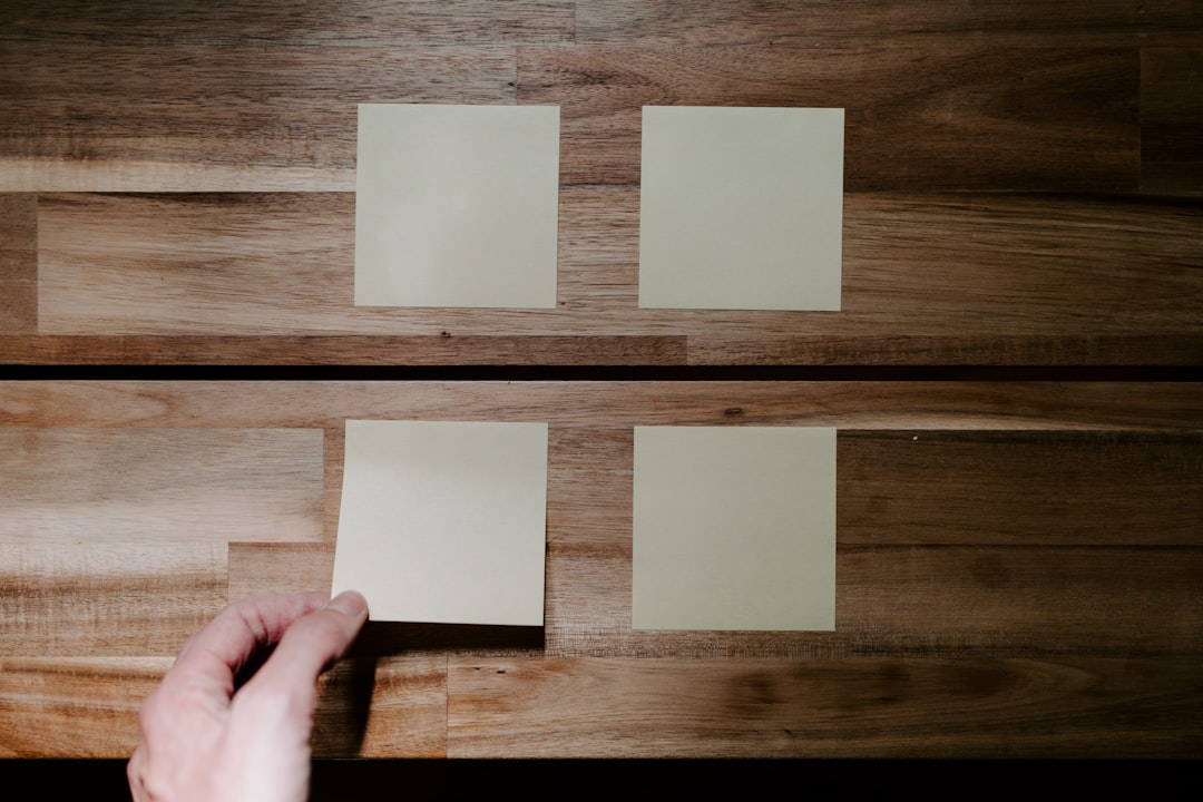 a hand holding a piece of paper,