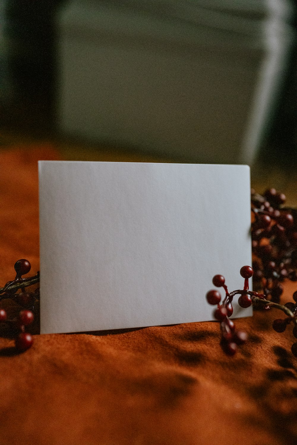 a white piece of paper with a key chain on a wooden surface