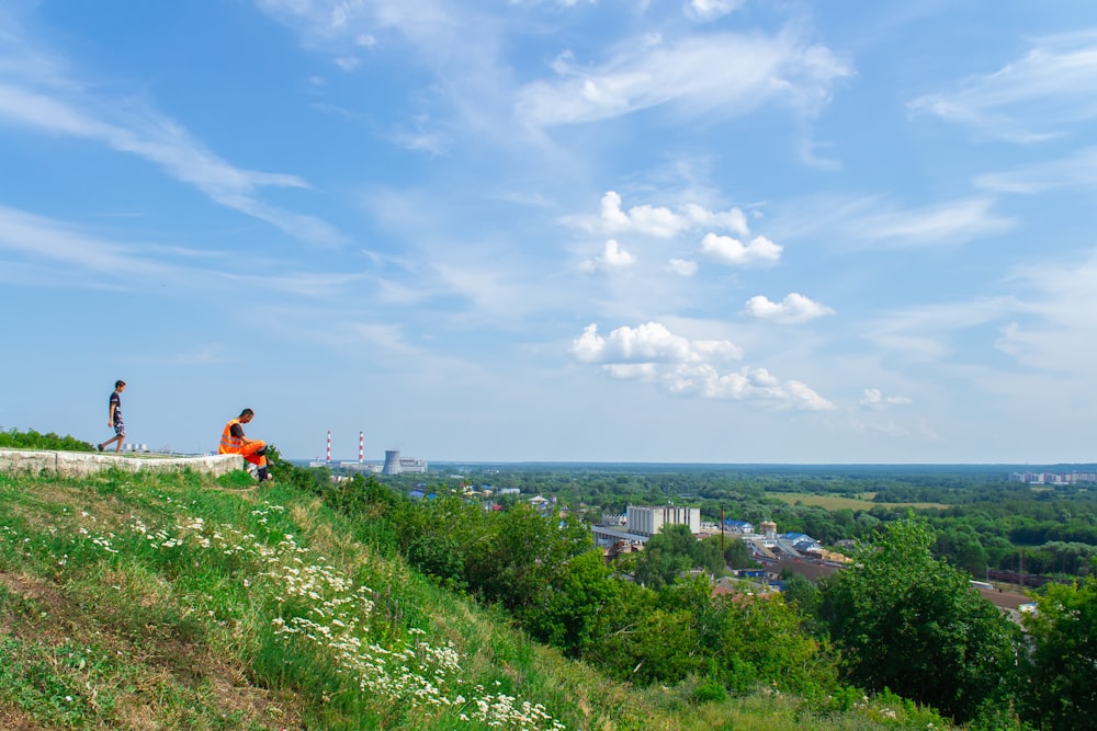 a couple people on a hill