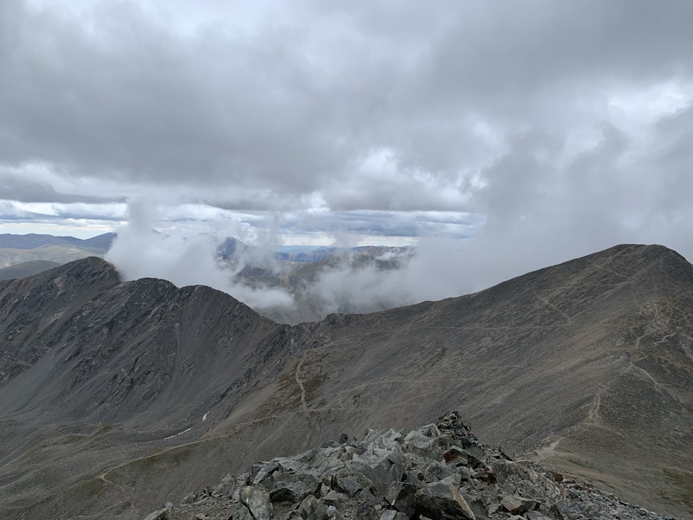 a rocky mountain with clouds