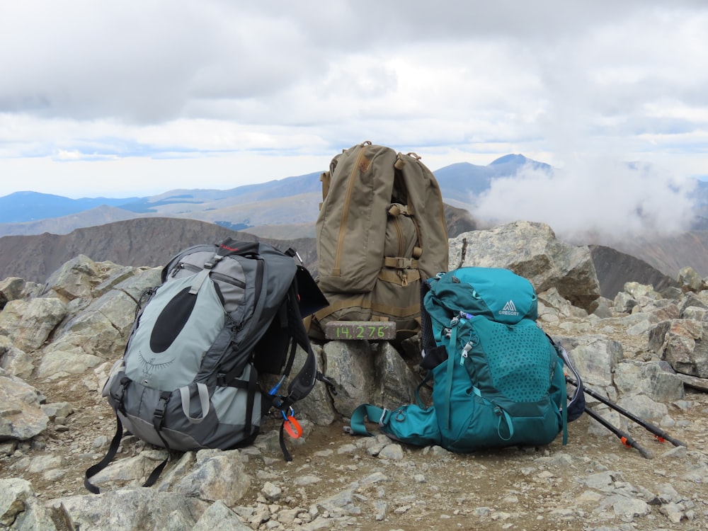 a couple of backpacks on a rocky mountain