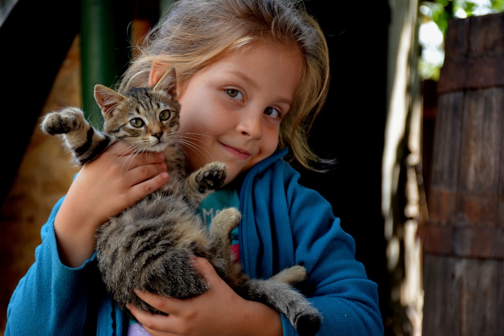 a girl holding a cat