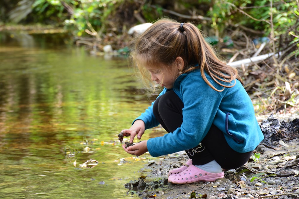 a girl kneeling in water