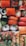 An assortment of sushi rolls arranged closely together, featuring a variety of ingredients including salmon, avocado, seaweed, and rice. Some rolls are topped with vibrant orange roe and garnished with herbs and slices of chili pepper.
