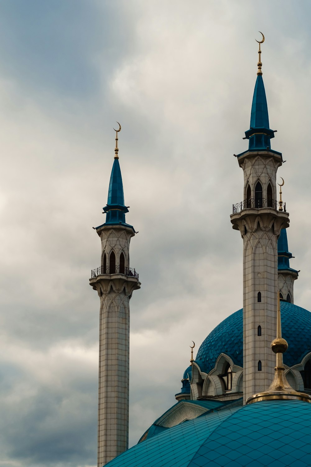 a couple of towers with blue rooftops and a blue sky