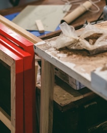 Various custom-cut laminated plastic shapes arranged on a workshop table.