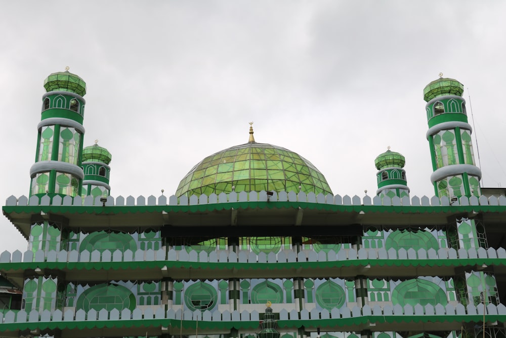 a building with green and white domes