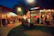 A cozy outdoor terrace at the club with diners enjoying fresh meals under soft evening lights.
