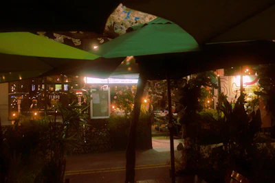 A cozy restaurant terrace with warm lighting and happy diners in the evening