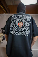 A close-up of a t-shirt featuring a unique QR code design.