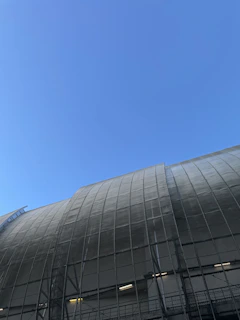 Modern industrial warehouse exterior with sleek steel structure under clear sky