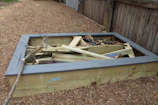 Step-by-step photo of building a raised garden bed in a backyard.